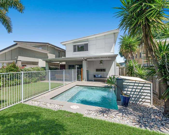 Contemporary home with swimming pool and fenced outdoor area, promoted by an overseas buyers agent Brisbane for luxury property seekers.